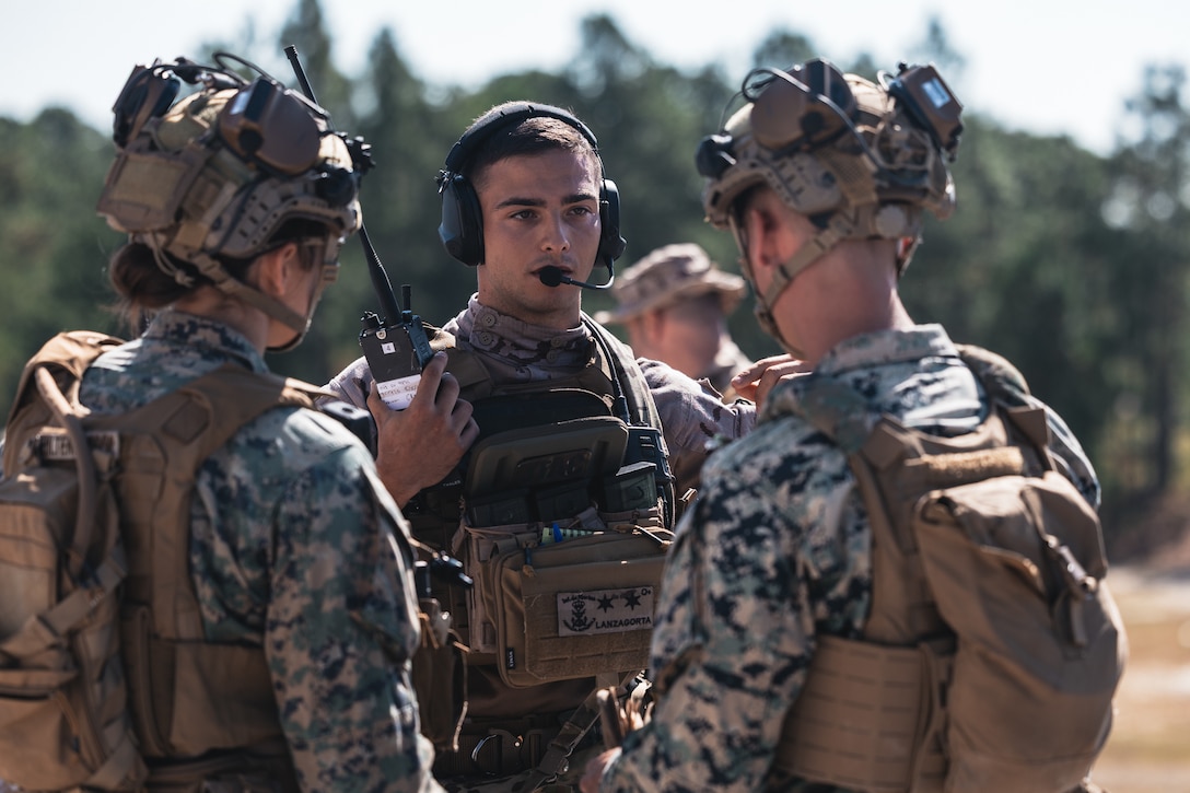 Teniente Gonzalo Lanzagorta, a marine with Infanteria de Marina (Spanish marines), speaks with U.S. Marines with Golf Company, 2nd Battalion, 2nd Marine Regiment during close air support training for exercise UNITAS 2025 at Marine Corps Base Camp Lejeune, North Carolina, Sept. 17, 2025. UNITAS, which is Latin for “unity,” was conceived in 1959 and has taken place annually since first conducted in 1960. This year marks the 66th iteration of the world’s longest running annual multinational maritime exercise. The exercise trains forces in joint maritime operations that enhance tactical proficiency and increase interoperability with the presence of unmanned air, surface and submarine systems. (U.S. Marine Corps photo by Sgt. Jorge Borjas)