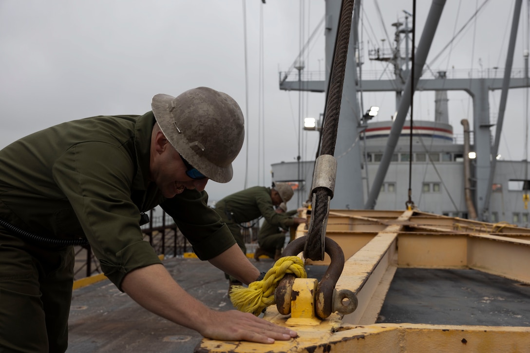 U.S. Marine Corps Gunnery Sgt. Zachary Pipher, from New York, and a mobility facility technician with Marine Aviation Logistics Squadron (MALS) 31, Marine Aircraft Group (MAG) 31, 2nd Marine Aircraft Wing, secures cargo while aboard the Military Sealift Command Wright-class aviation logistics support ship SS Wright (T-AVB-3) during Exercise Carolina Dragon 25 at Naval Station Norfolk, Virginia, Sept. 16, 2025. Carolina Dragon 25 is a 2nd MAW and Expeditionary Strike Group 2 exercise designed to validate and exercise the SS Wright’s capabilities and to prepare and confirm readiness for incorporation into future 2nd MAW exercises and contingency operations. (U.S. Marine Corps photo by Lance Cpl. Bryan Giraldo)