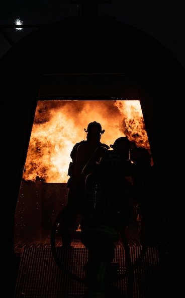 The 5th Civil Engineer Squadron’s fire protection team extinguishes an ongoing fire during a live aircraft fire exercise at Minot Air Force Base, North Dakota, Sept. 16, 2025. Live burn training keeps firefighters prepared and provides them with a realistic fire experience before responding to an emergency. (U.S. Air Force photo by Senior Airman Alyssa Bankston)