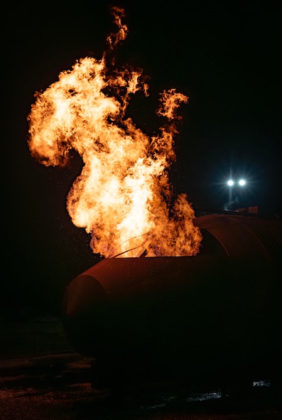 An aircraft fire training facility burns during a live fire exercise at Minot Air Force Base, North Dakota, Sept. 16, 2025. Live burn training keeps firefighters prepared and provides them with a realistic fire experience before responding to an emergency. (U.S. Air Force photo by Senior Airman Alyssa Bankston)