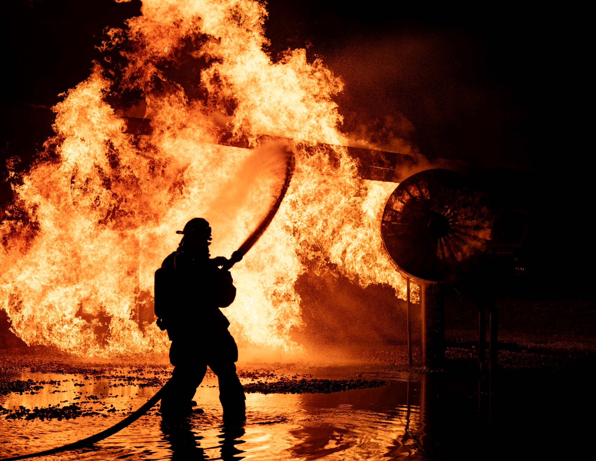5th Civil Engineer Squadron fire protection specialists extinguish an ongoing fire during a live aircraft fire exercise at Minot Air Force Base, North Dakota, Sept. 16, 2025. A fire hose's typical operating pressure ranges from 116 to 290 pounds per square inch. (U.S. Air Force photo by Senior Airman Alyssa Bankston)