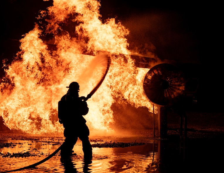 5th Civil Engineer Squadron fire protection specialists extinguish an ongoing fire during a live aircraft fire exercise at Minot Air Force Base, North Dakota, Sept. 16, 2025. A fire hose's typical operating pressure ranges from 116 to 290 pounds per square inch. (U.S. Air Force photo by Senior Airman Alyssa Bankston)