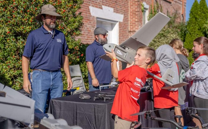 FREDERICKSBURG, Va. – A student holds a Raven, a battery-powered fix-winged drone, at Naval Surface Warfare Center Dahlgren Division's Dahlgren Downtown in 2024 in Fredericksburg, Virginia. (Dorina Watermolen/NSWCDD photo)
