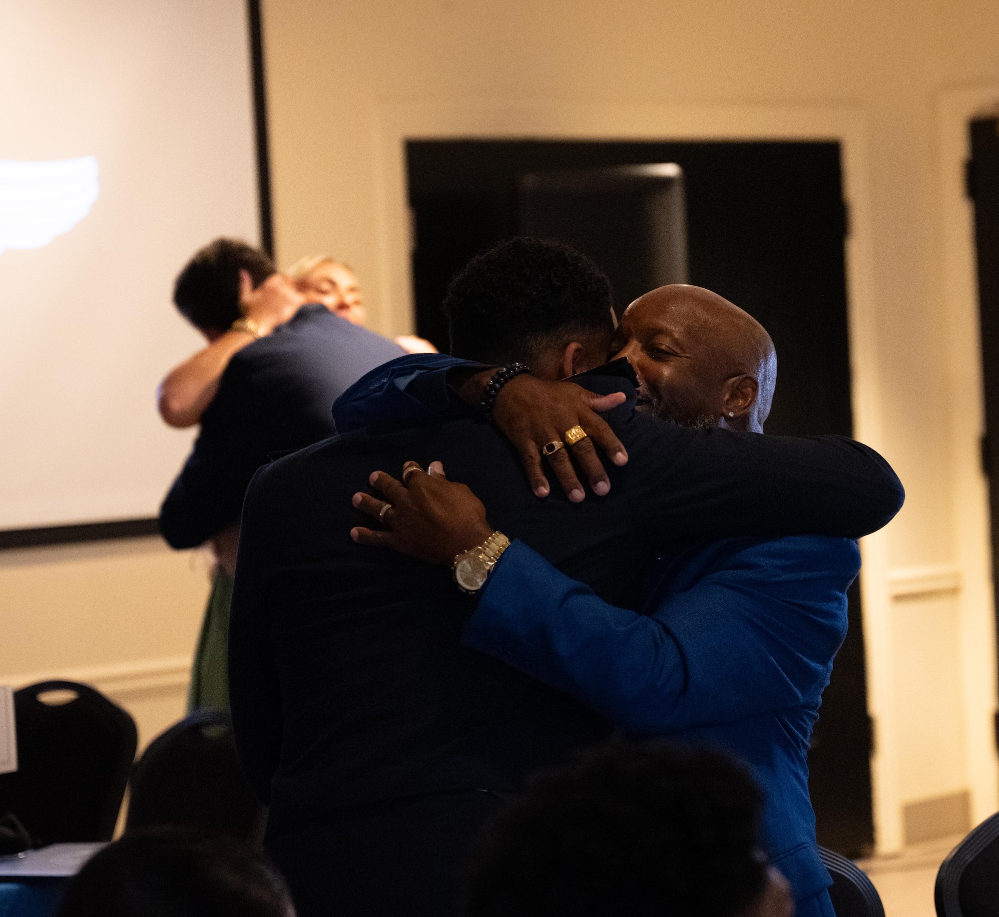 U.S. Air Force Airmen from graduating Class 25-15 present one half of their broken wings to their loved ones at Laughlin Air Force Base, Texas, Sept. 18, 2025.  Thirty-four U.S. Air Force officers were awarded silver wings during the ceremony, symbolizing their completion of the Undergraduate Pilot Training program. (U.S. Air Force photo by Airman 1st Class Harrison Sullivan)