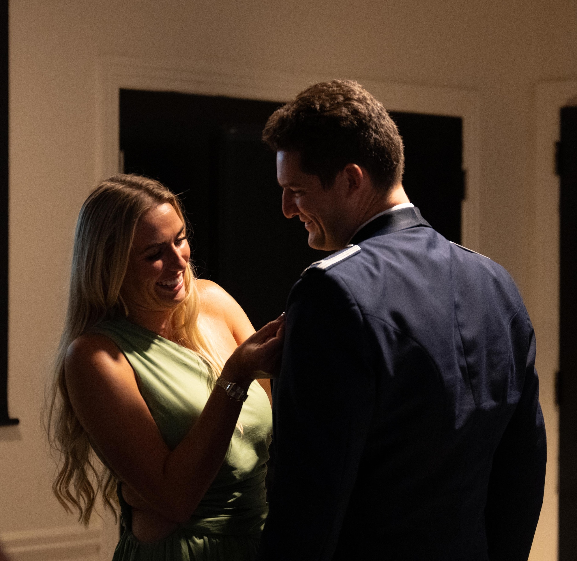 Loved ones pin silver wings on their graduate during a graduation ceremony of Class 25-15 at Laughlin Air Force Base, Texas, Sept. 15, 2025. Thirty-four U.S. Air Force officers were awarded silver wings during the ceremony, symbolizing their completion of the Undergraduate Pilot Training program. (U.S. Air Force photo by Airman 1st Class Harrison Sullivan)