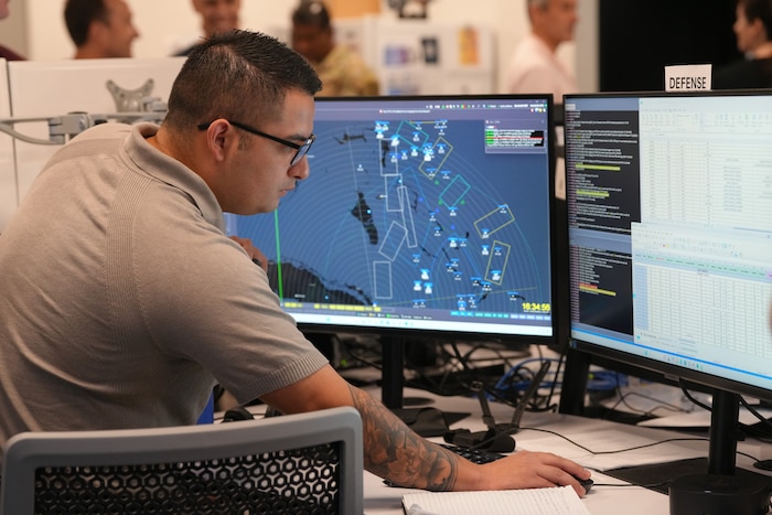 people working on computers in a room