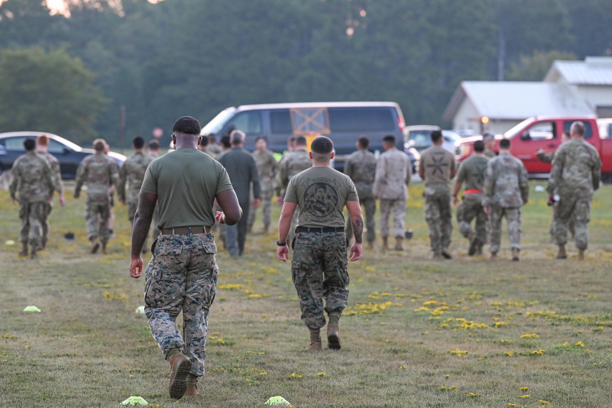 A group of men in uniform walk down a field.