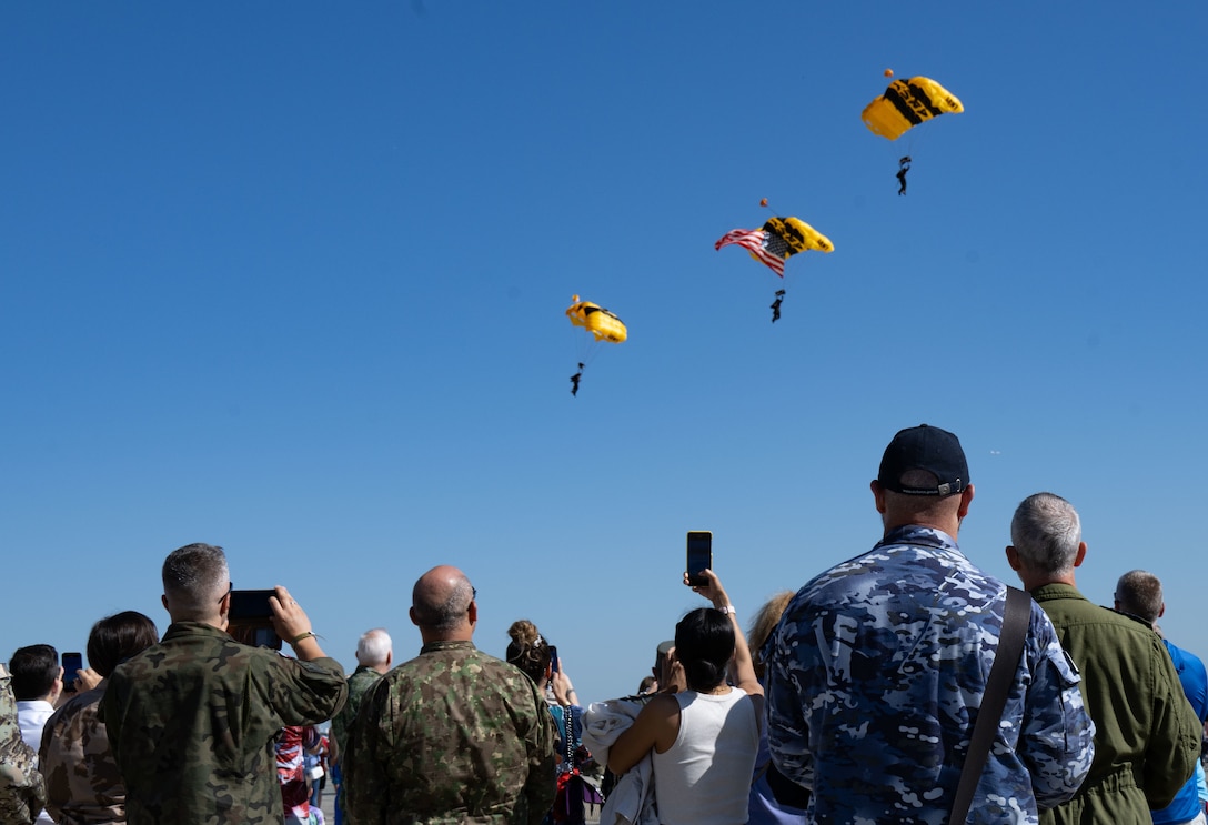 Spectators of the 2025 Joint Base Andrews Air Show watch the U.S. Army Golden Knights Parachute Team descend onto the flightline.