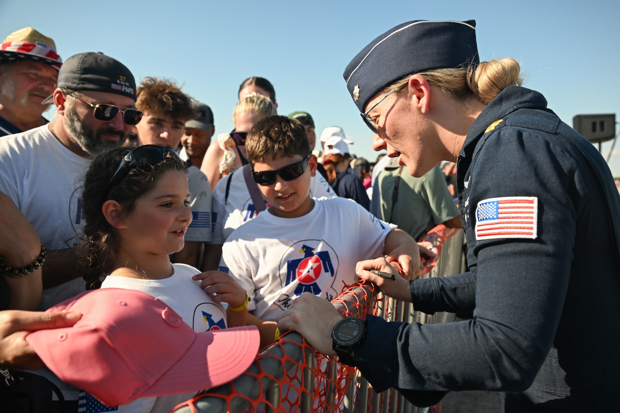 Maj. Laney Schol, opposing solo for the U.S. Air Force Air Demonstration Squadron speaks to a young fan after performing at the 2025 Joint Base Andrews Air Show.