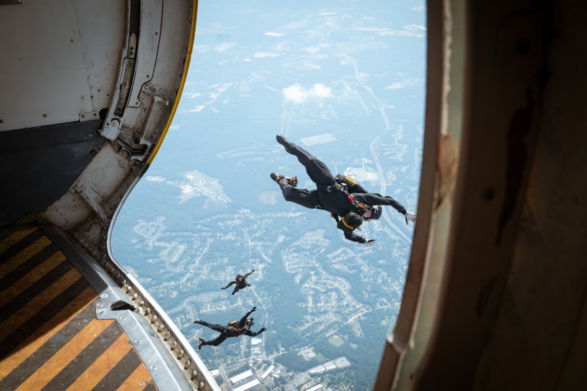 Members of the U.S. Army Golden Knights parachute team descend from the sky during the 2025 Joint Base Andrews Air Show.