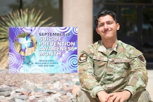 U.S. Air Force Airman 1st Class Antonio Mendoza, 355th Civil Engineer Squadron water and fuel systems technician, poses with a Suicide Prevention and Awareness Month sign at Davis-Monthan Air Force Base, Arizona, September 18, 2025. Mendoza is Applied Suicide Intervention Skills Training certified, enhancing his ability to help Airmen in times of crisis. (U.S. Air Force photo by Airman 1st Class Jaden Kidd)