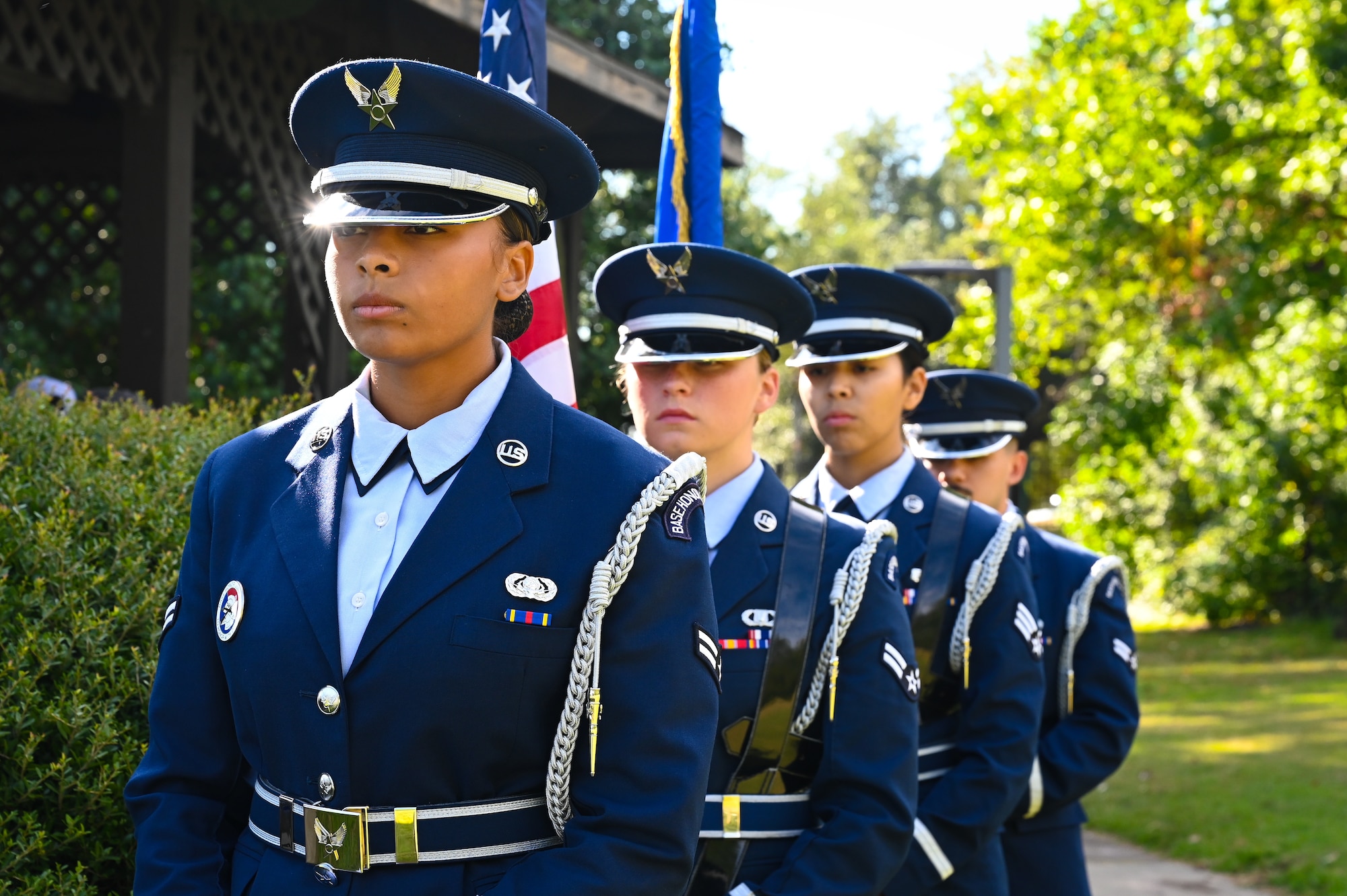 The sun reflects off the ceremonial hat worn by the lead Shaw Air Force Base Honor Guardsman. A four-person detail stands in a line outside waiting for the call to march and present the colors for the U.S. national anthem during a POW/MIA ceremony.