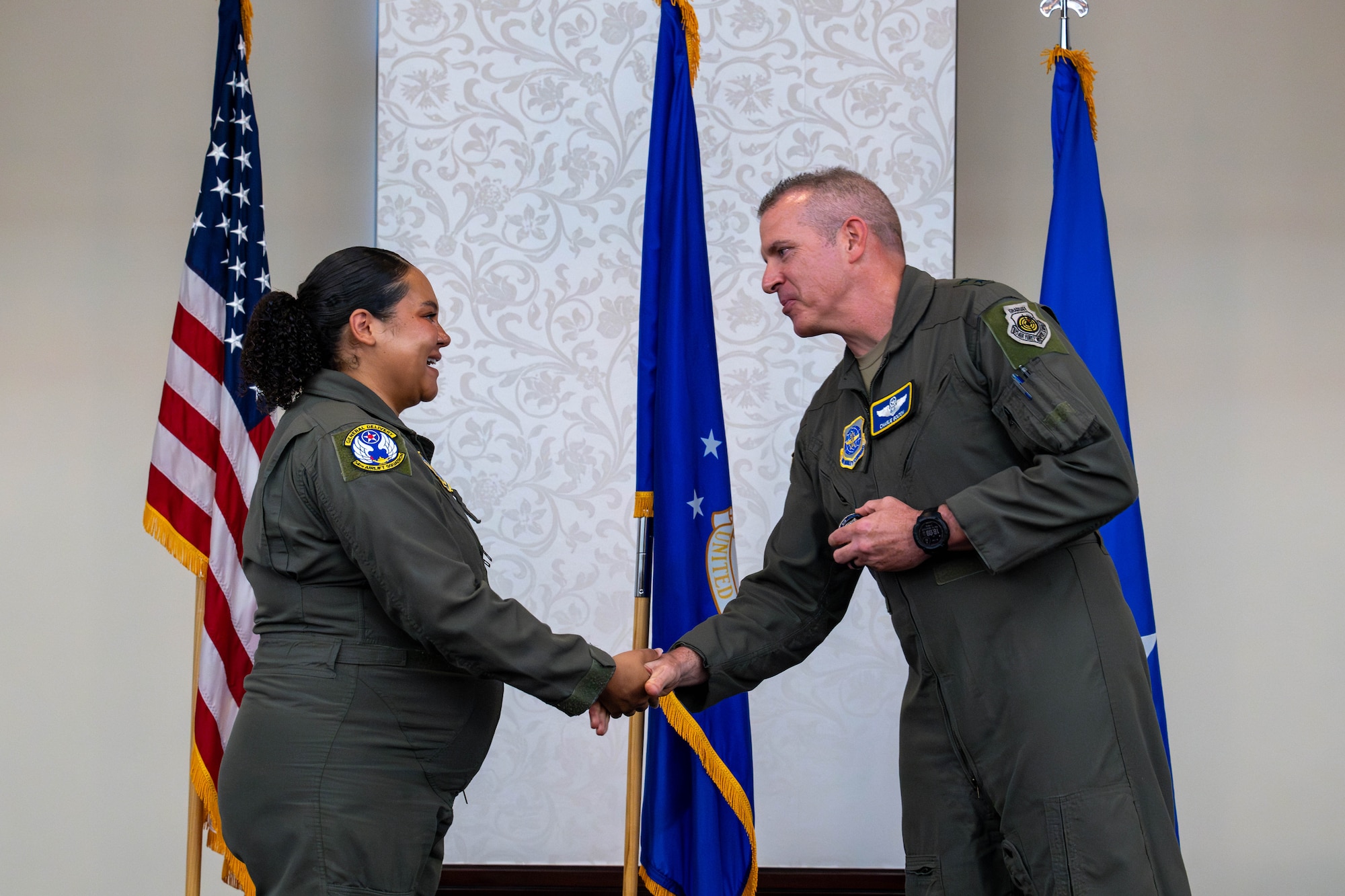 General shakes Airman's hand