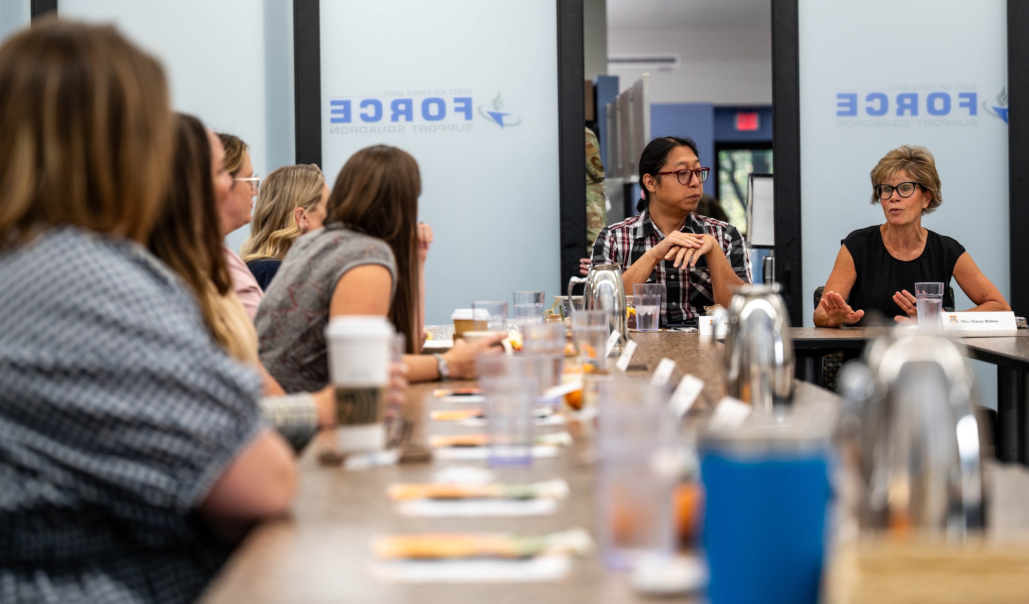 Woman speaks to table of women