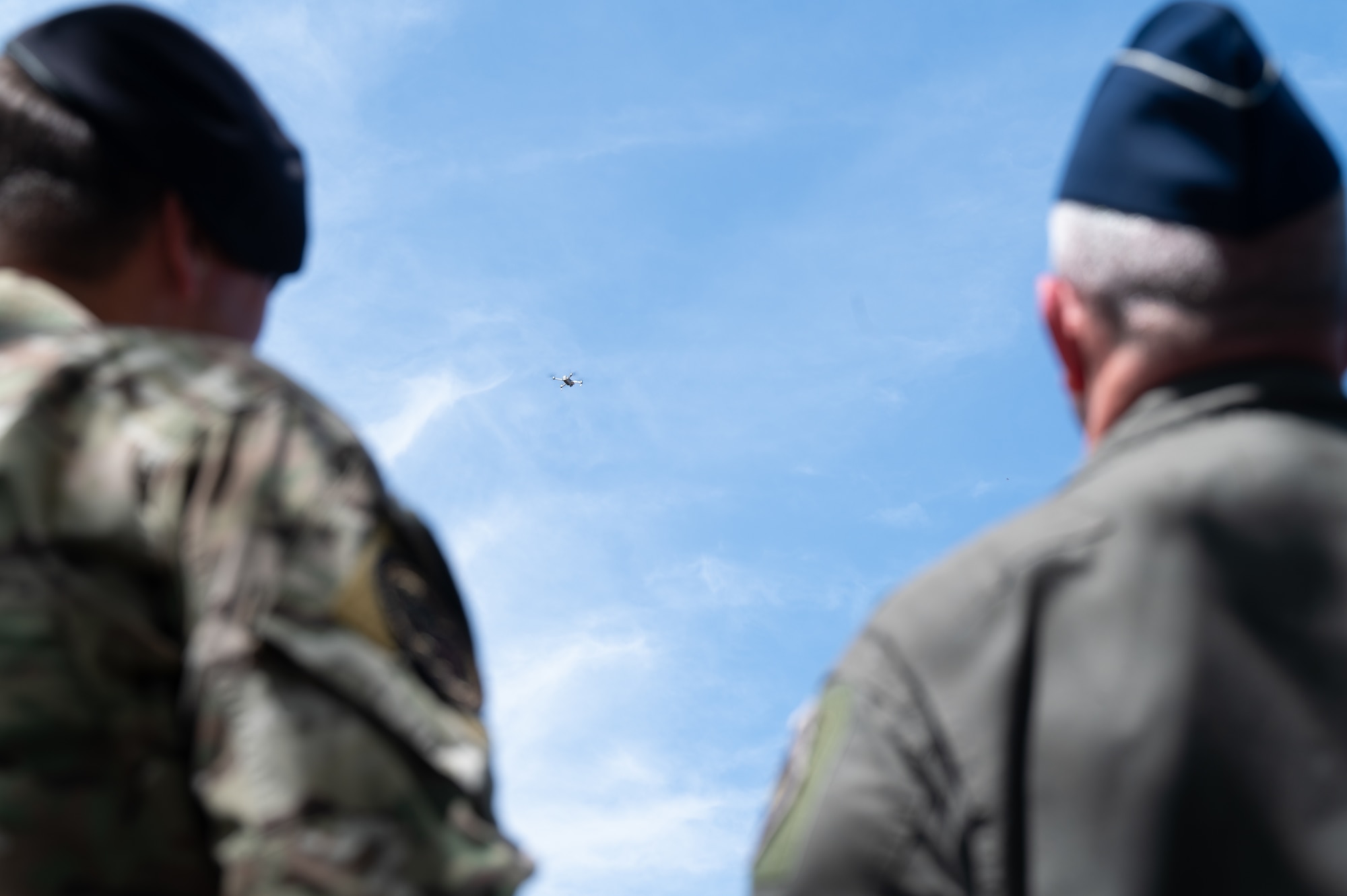 Drone flies above Airmen