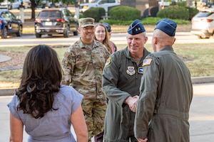 General shakes hands