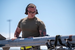 U.S. Air Force Staff Sgt. Cody Rhodes, 57th Aircraft Maintenance Squadron weapons load crew chief, inspects a missile during Weapons System Evaluation Program Combat Archer 25.09 at Tyndall Air Force Base.