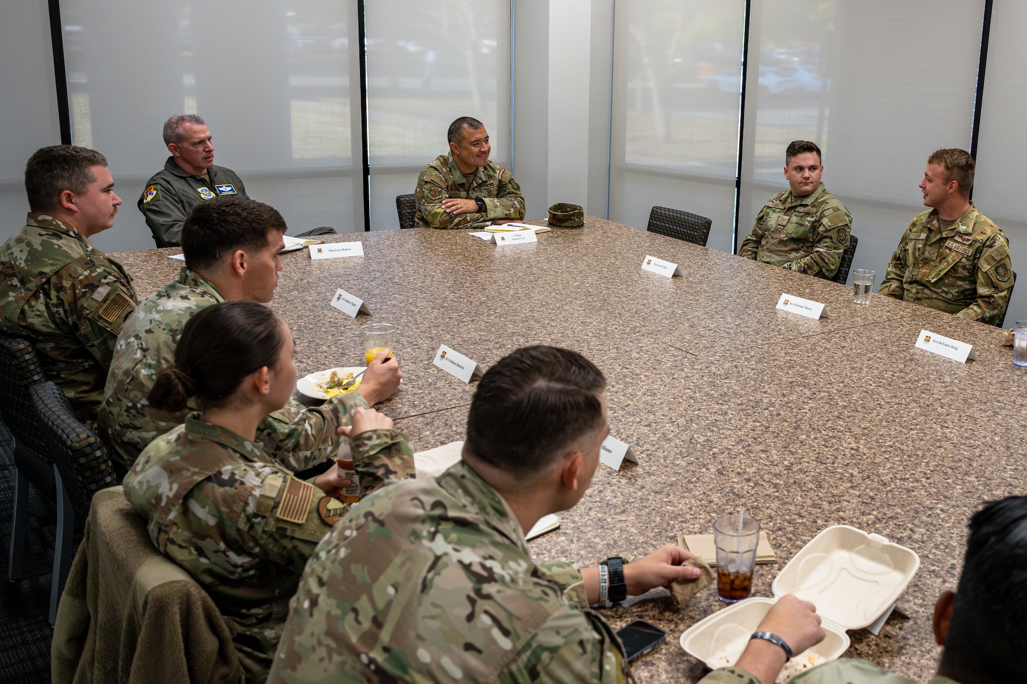 Service members sit around a table