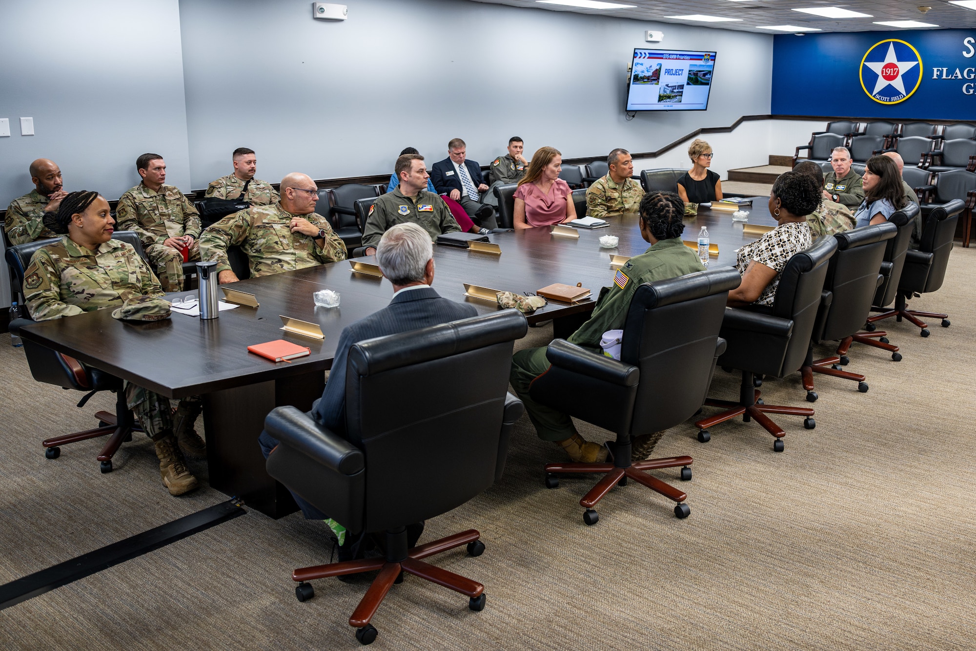 Service members sit around a table