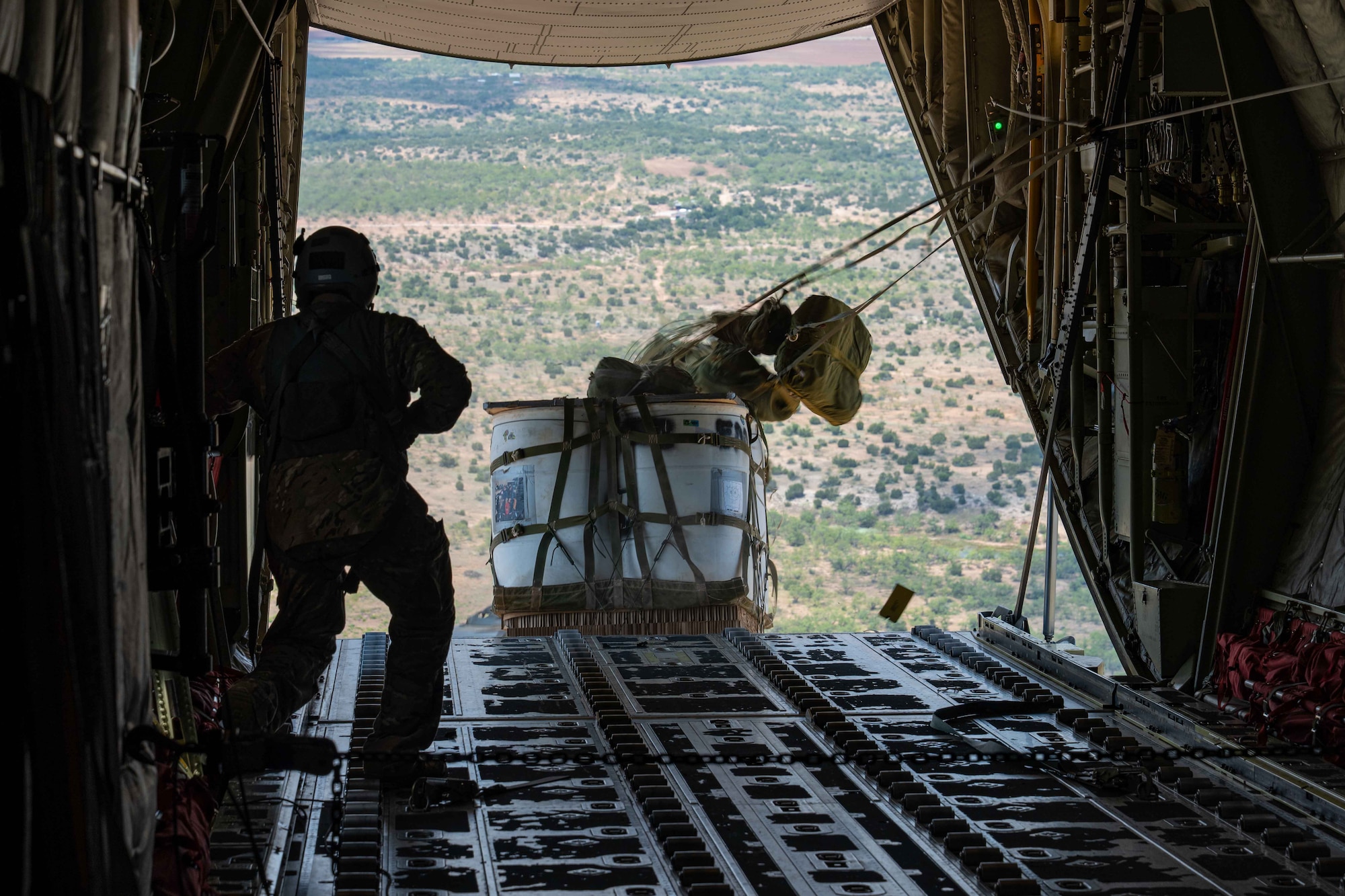 U.S. Air Force Senior Airman Tobin Moore, 40th Airlift Squadron loadmaster, conducts a Container Delivery System airdrop from a C-130J Super Hercules assigned to the 317th Airlift Wing, near Dyess Air Force Base, Texas, Aug. 26, 2025. Regular airdrop training ensures 317th AW loadmasters maintain expertise in delivering critical supplies and equipment to diverse locations. (U.S. Air Force photo by Senior Airman Jade M. Caldwell)