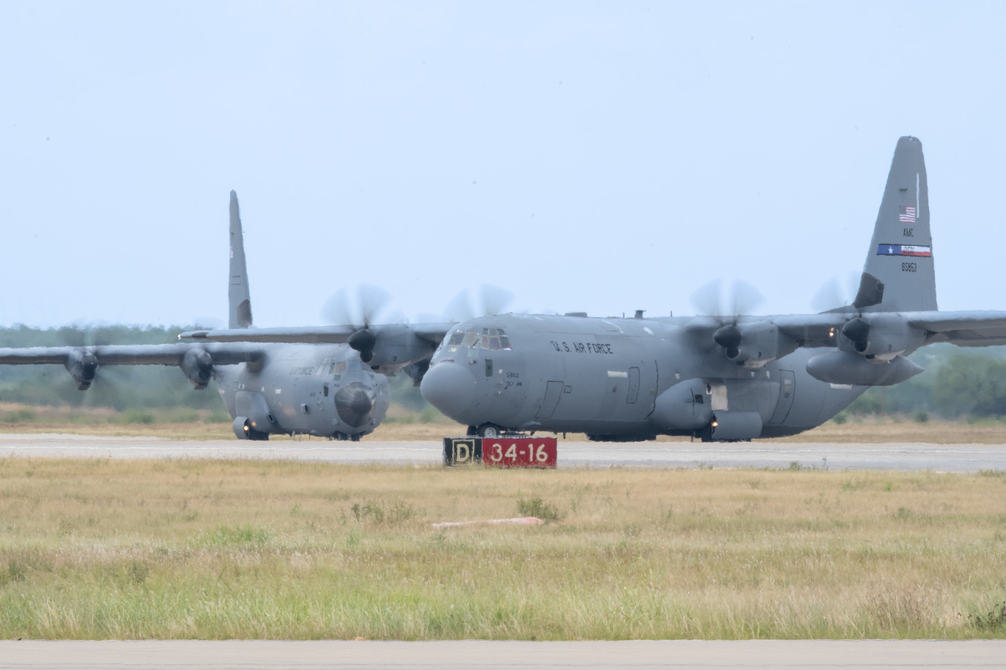 U.S. Air Force C-130J Super Hercules aircraft assigned to the 317th Airlift Wing taxi on the flightline after landing at Dyess Air Force Base, Texas, Aug. 26, 2025.  During the local training sortie, aircrews conducted low-level flying and formation maneuvers to maintain proficiency in a variety of flight capabilities. (U.S. Air Force Photo by Airman 1st Class Caleb Schellenberg)