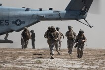 U.S. Marines assigned to Charlie Battery, 1st Battalion, 11th Marine Regiment, 1st Marine Division, exit a CH-53E Super Stallion helicopter assigned to Marine Heavy Helicopter Squadron (HMH) 465, Marine Aircraft Group 16, 3rd Marine Aircraft Wing, during a helo raid as part of Exercise Cobra Fury 25.5 at Marine Corps Base Camp Pendleton, California, Sept. 11, 2025. Cobra Fury 25.2 is an annual exercise designed to improve the battalion’s ability to deploy artillery and M142 High Mobility Artillery Rocket Systems to provide accurate, long-range fire in key terrain. (U.S. Marine Corps photo by Lance Cpl. Diego Berumen)