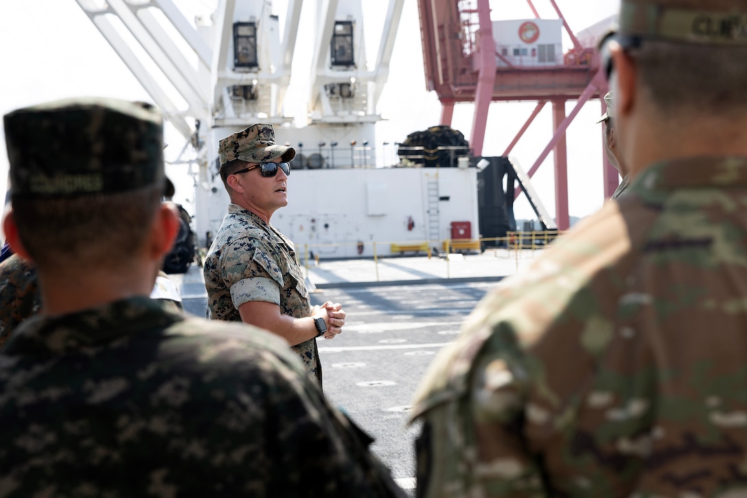 U.S. Marine Corps Chief Warrant Officer 3 Alexander Woodward, port operations officer in charge at Blount Island Command, explains cargo loading procedures Sept. 19, 2025, during a tour aboard the USNS Sgt. William W. Seay, a cargo ship operated by the U.S. Navy’s Military Sealift Command, at Marine Corps Support Facility Blount Island in Florida. The ship visit was part of a WHINSEC tour highlighting how the Marine Corps’ prepositioning programs support rapid global response. (U.S. Marine Corps photo by Dustin Senger)