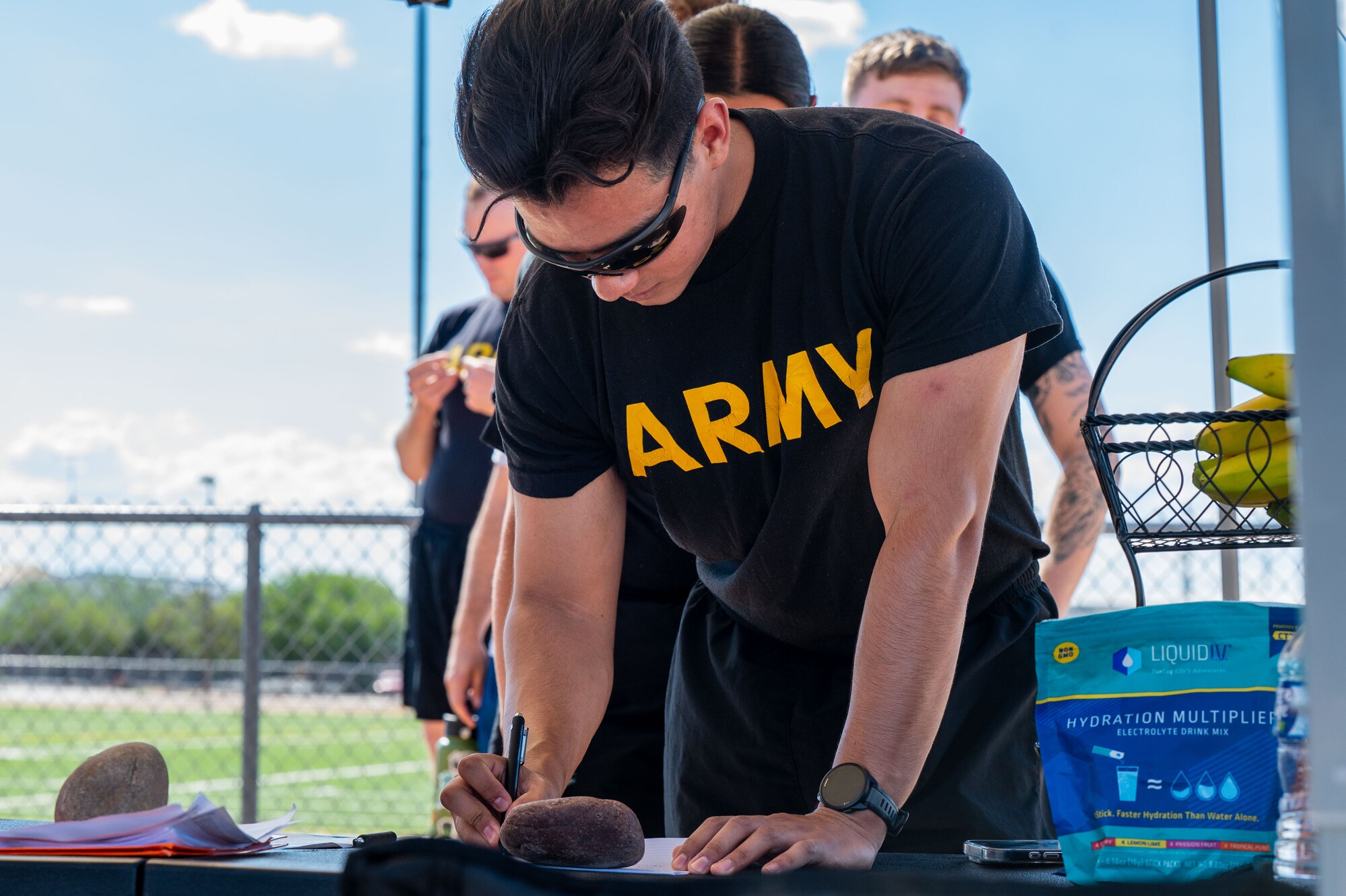 A U.S. Soldier assigned to the 2nd Battalion, 12th Infantry Regiment, signs in at the Prisoner of War and Missing in Action Remembrance Run at Davis-Monthan Air Force Base, Arizona, Sept. 18, 2025. Members of the Desert Lightning Team volunteered to keep the flag in motion for 24 hours to honor prisoners of war and those missing in action. (U.S. Air Force photo by Senior Airman Jasmyne Bridgers-Matos)