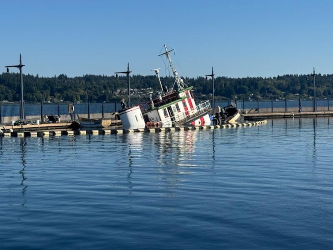 A tug begins to sink near in the Bremerton Marina, near Bremerton, Washington, Sept. 17, 2025, causing pollution.