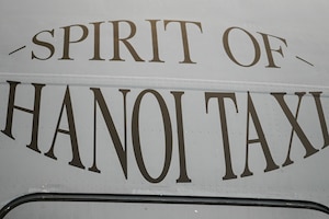 The newly re-designated name, “Spirit of Hanoi Taxi,” is shown on a C-17 Globemaster III with tail number 99-0165 during an unveiling ceremony at Wright-Patterson Air Force Base, Ohio, Sept. 19, 2025. The renaming was part of Operation Honor, paying tribute to the bond between the 445th Airlift Wing and the original C-141 Starlifter Hanoi Taxi, which repatriated American POWs from Vietnam and brought them back home.  (U.S. Air Force photo by Staff Sgt. Johnathan Quiñones)