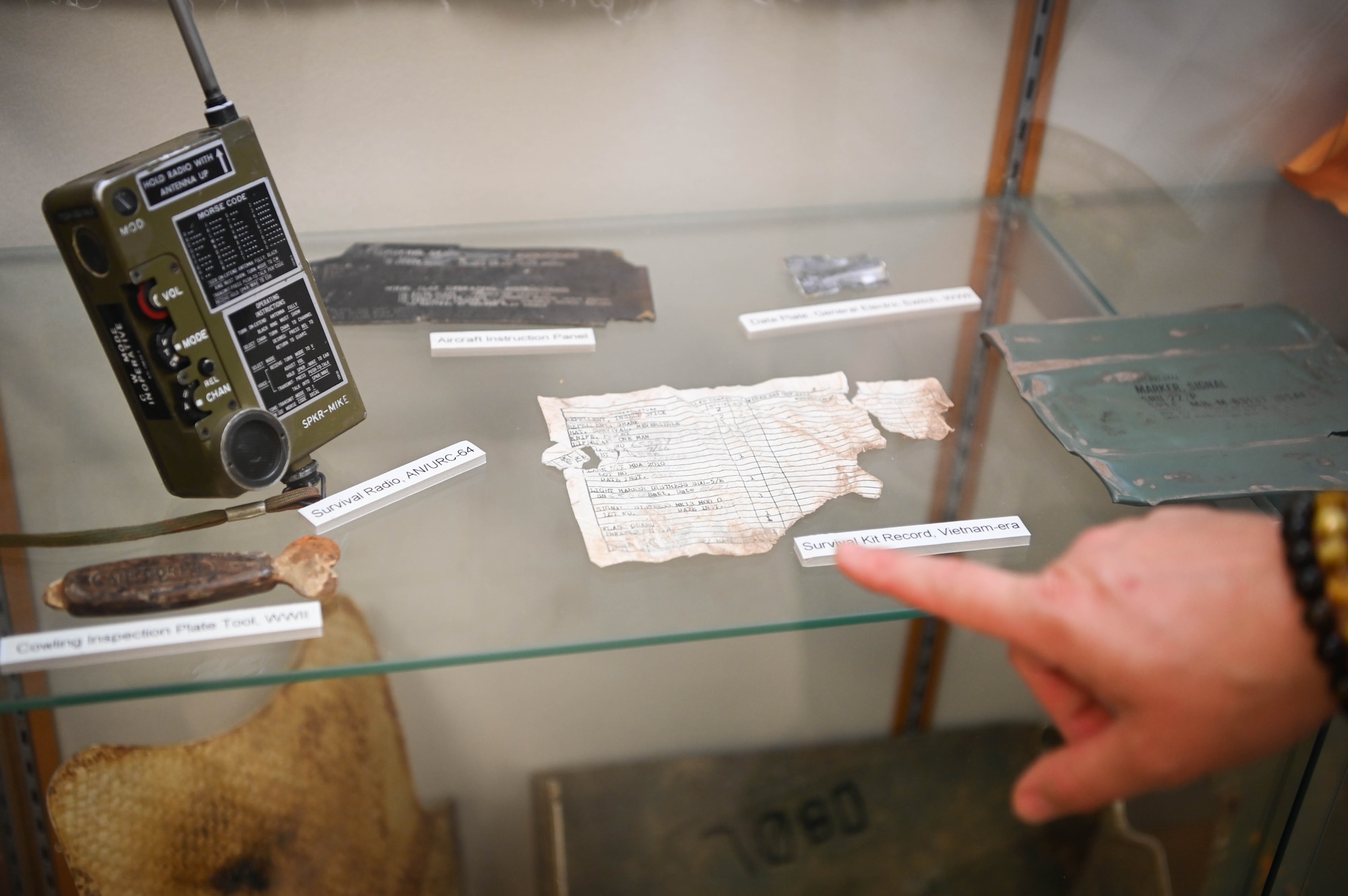 Items from different conflict eras are shown on display at the DPAA facility on Offutt Air Force Base, Neb., Sept. 16, 2025. Military relics, such as those on display, could possibly be found at excavation sites where unidentified remains are recovered, and are used as material evidence to help in the identification process. (U.S. Air Force photo by Daniel Martinez)