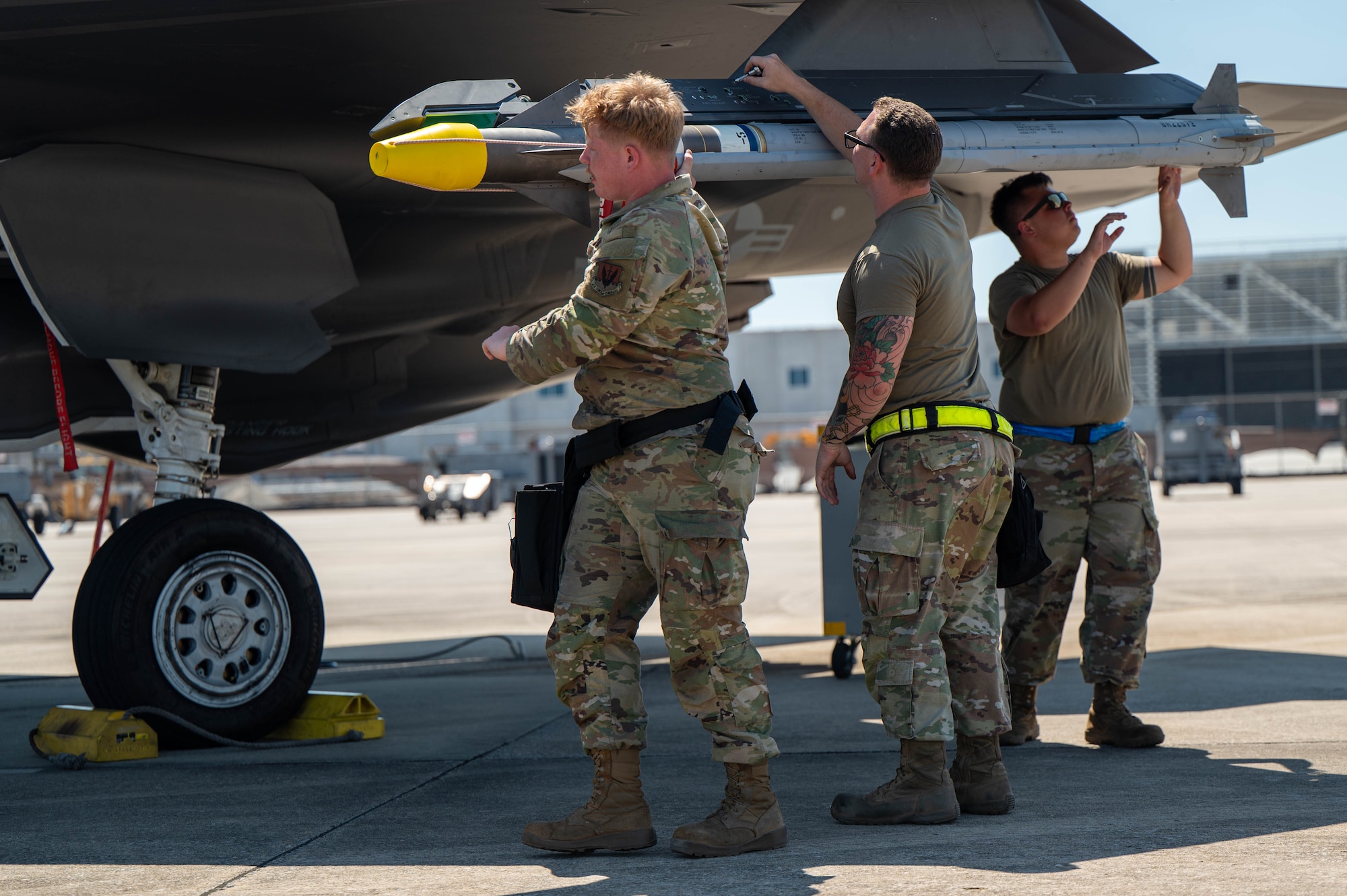 Airmen assigned to the 57th Aircraft Maintenance Squadron, secure a missile onto an F-35A Lightning II during Weapons System Evaluation Program Combat Archer 25.09 at Tyndall Air Force Base.