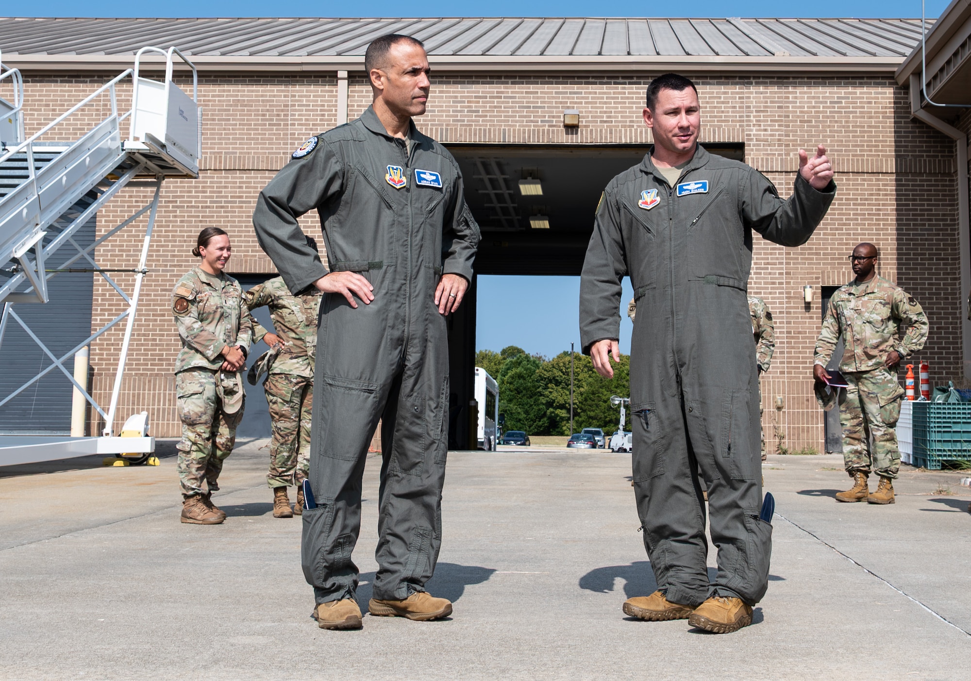 U.S. Air Force Gen. Adrian Spain, commander of Air Combat Command, left, and Col. Hugh Walker, 20th Fighter Wing acting commander, right, are talking.