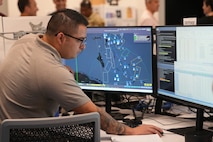 people working on computers in a room