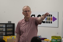 a person standing holds his left hand in the air