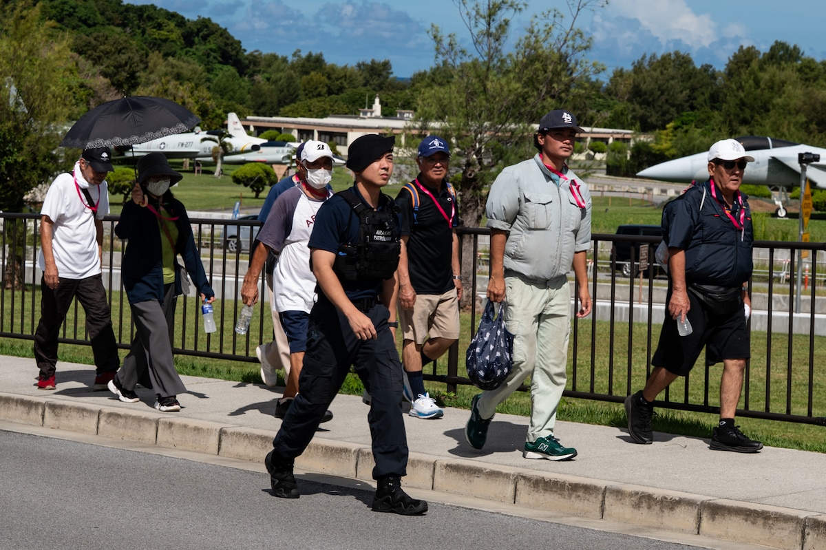 Chatan Town residents and a civilian police officer walk the tsunami evacuation route on Kadena Air Base.