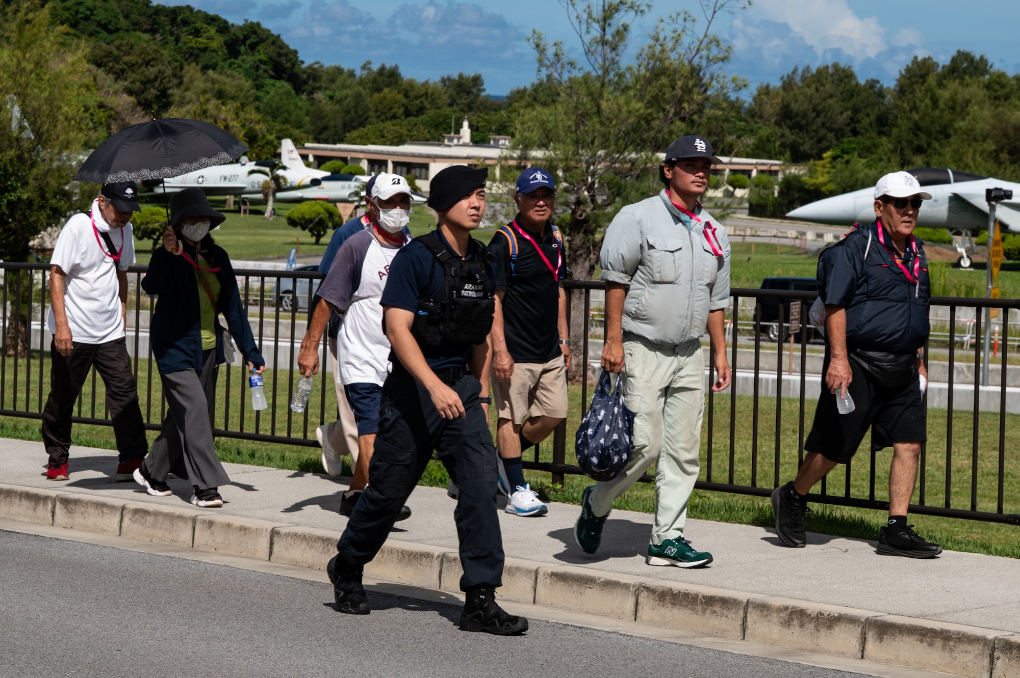 Chatan Town residents and a civilian police officer walk the tsunami evacuation route on Kadena Air Base.