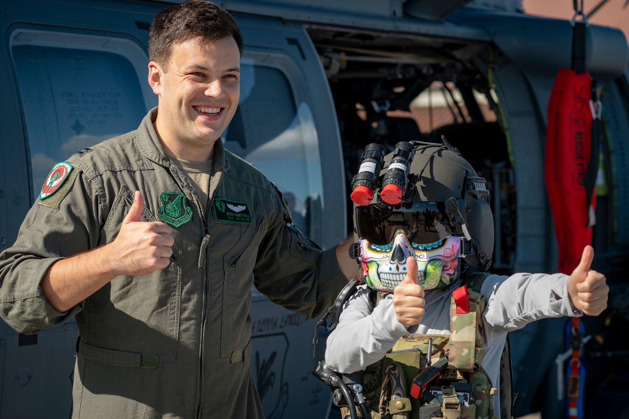 A U.S. Air Force UH-60 Black Hawk pilot and an attendee pose for a photo during Air Fest 2025 at Misawa Air Base, Japan, Sept. 21, 2025.