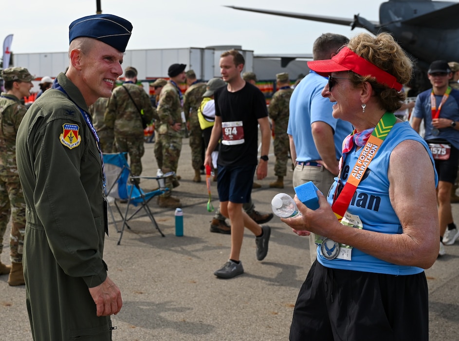 U.S. Air Force Col. Matthew T. Muha, left, 445th Airlift Wing deputy commander, congratulates a participant of the 29th annual Air Force Marathon at Wright-Patterson Air Force Base, Ohio, Sept. 20, 2025. (U.S. Air Force photo by Staff Sgt. Johnathan Quiñones)