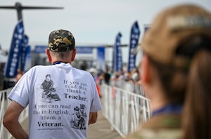 U.S. Marine Vietnam veteran Jim Smith, left, waits to don finisher medals on participants of the Air Force Marathon at Wright-Patterson Air Force Base, Ohio, Sept. 20, 2025. As part of Operation Honor 2025, veterans were on hand to cheer on runners and present medals to winners while also engaging with younger generations of service members before tomorrow's historic Honor Flight on an Air Force Reserve C-17 Globemaster III assigned to the 445th Airlift Wing. (U.S. Air Force photo by Staff Sgt. Johnathan Quiñones)