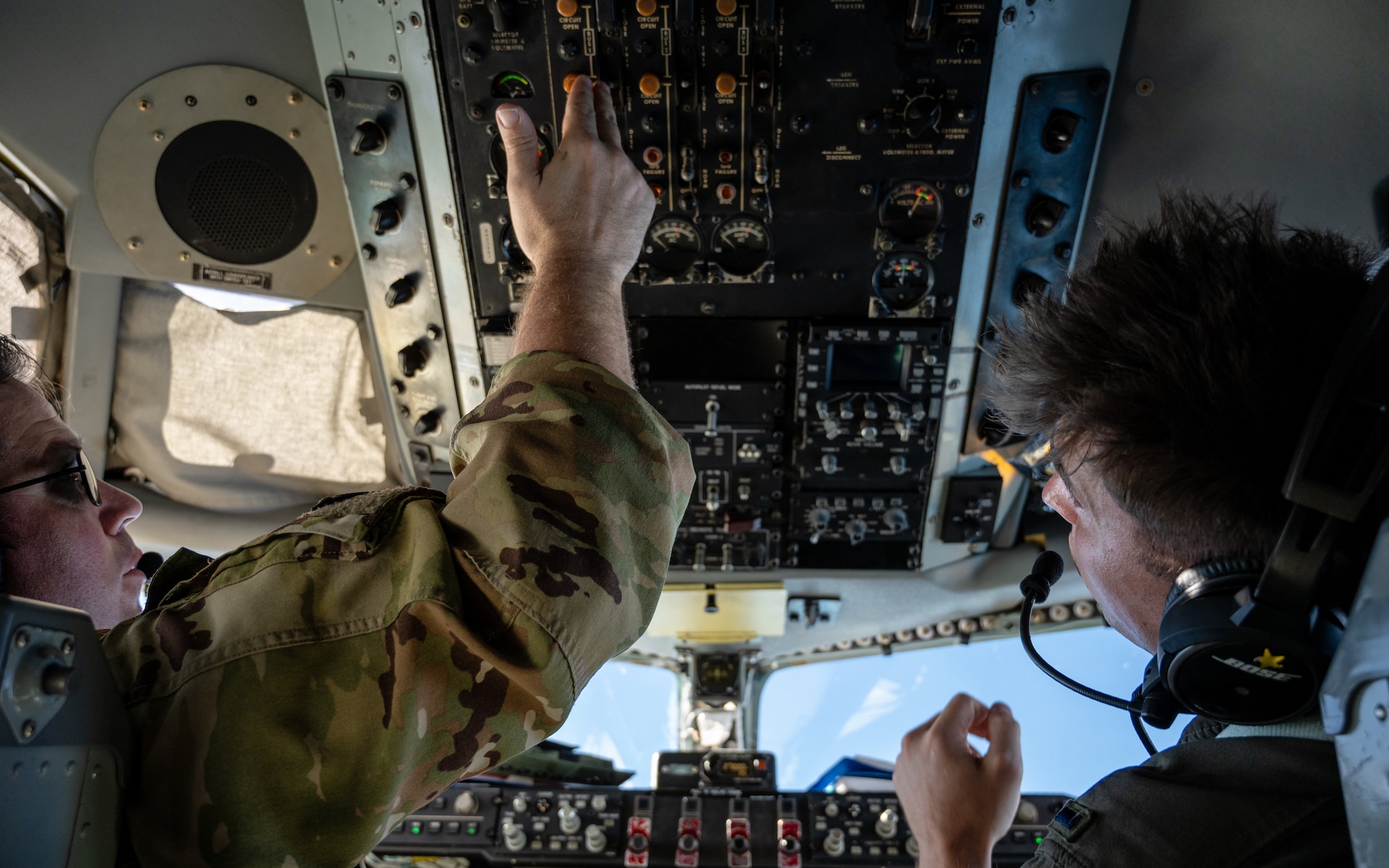 U.S. Air Force Lt. Col. Clark Hall, left, and 1st Lt. Jacob Spiewak, 91st Air Refueling Squadron KC-135 Stratotanker pilots, operate controls on a KC-135 during an air refueling mission Sept. 12, 2025, supporting exercise Combat Archer over the Gulf of America.  Combat Archer provides the 6th Air Refueling Wing an opportunity to integrate with fighter units during live-fire air-to-air weapons evaluations. With rapid, reliable refueling, AMC tankers extend sorties and sustain combat operations, allowing fighters to concentrate on weapons employment and underscoring air mobility as a critical enabler of combat readiness.(U.S. Air Force photo by Tech. Sgt. Alexander Cook)