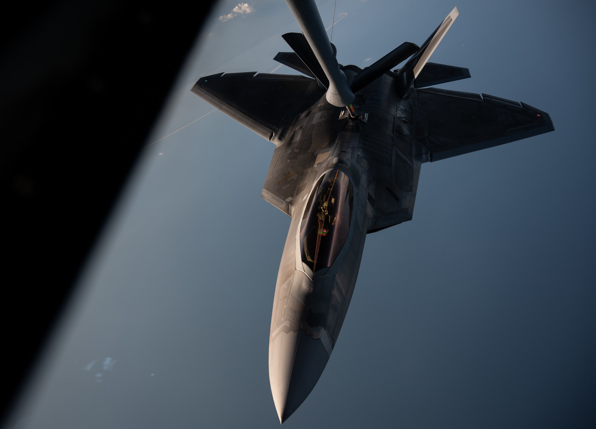 A U.S. Air Force F-22 Raptor assigned to the 433rd Weapons Squadron receives fuel from a KC-135 Stratotanker assigned to the 91st Air Refueling Squadron during exercise Combat Archer, Sept. 12, 2025, over the Gulf of America. Combat Archer provides the 6th Air Refueling Wing an opportunity to integrate with fighter units during live-fire air-to-air weapons evaluations. With rapid, reliable refueling, AMC tankers extend sorties and sustain combat operations, allowing fighters to concentrate on weapons employment and underscoring air mobility as a critical enabler of readiness. (U.S. Air Force photo by Tech. Sgt. Alexander Cook)