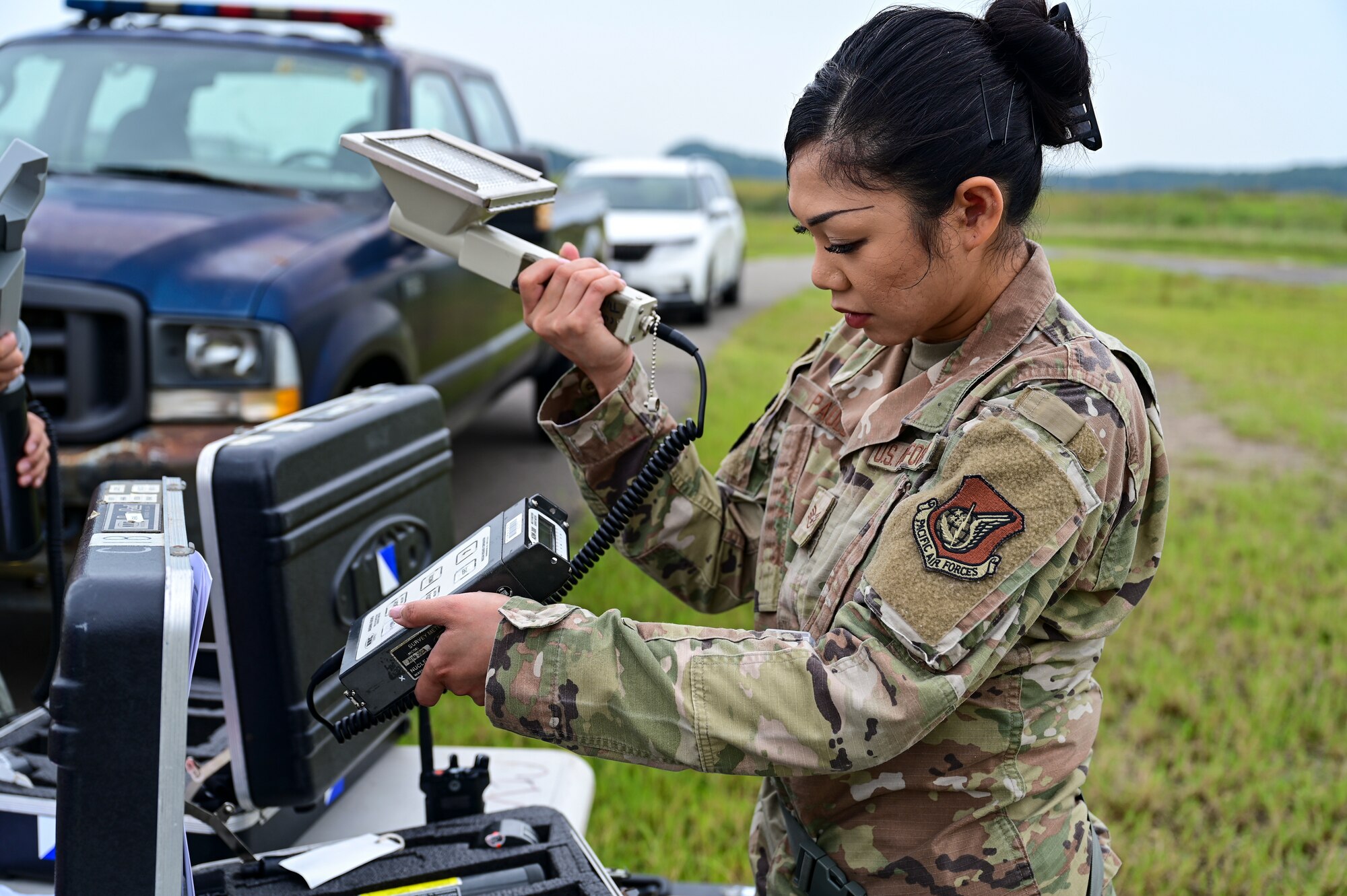 A woman holds a scanner.