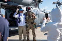 A U.S. Air Force member and an attendee pose for a photo during Air Fest 2025 at Misawa Air Base, Japan, Sept. 21, 2025.