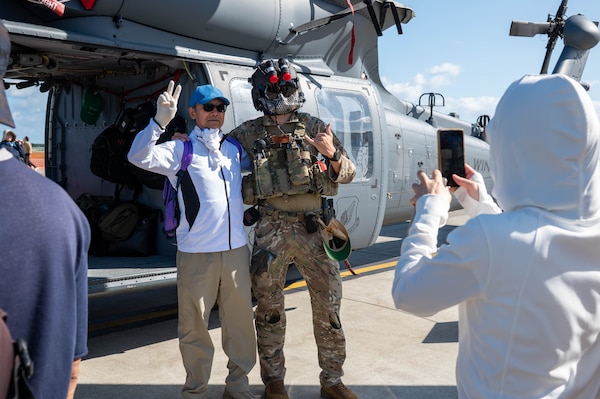 A U.S. Air Force member and an attendee pose for a photo during Air Fest 2025 at Misawa Air Base, Japan, Sept. 21, 2025.