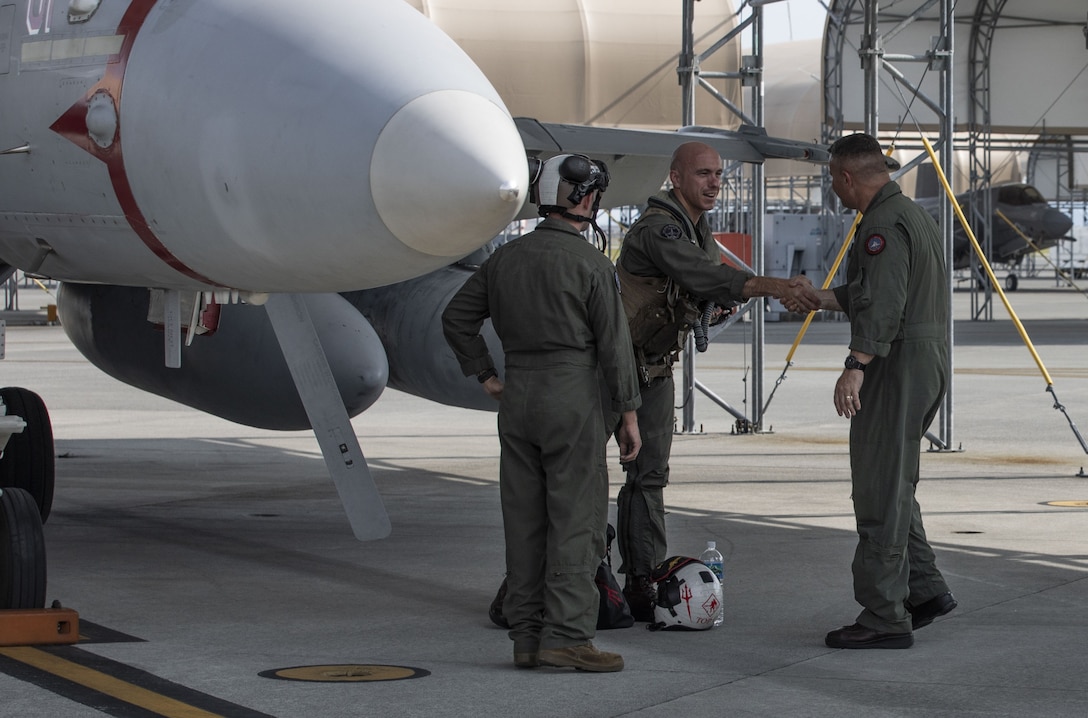 U.S. Marine Corps Col. William B. Millett III, right, the commanding officer of Marine Aircraft Group 12, 1st Marine Aircraft Wing, greets Marines from Marine Fighter Attack Squadron (VMFA) 232, MAG-12, 1st MAW, at Marine Corps Air Station Iwakuni, Japan, Sept. 8, 2025. VMFA-232, an F/A-18 Hornet squadron from MCAS Miramar, California, deployed to augment MAG-12, 1st MAW under the Unit Deployment Program, which provides U.S.-based units with operational experience in the Indo-Pacific through continuous and overlapping deployments to the region. Millett is a native of Massachusetts. (U.S. Marine Corps photo by Lance Cpl. Cecilia Campbell)