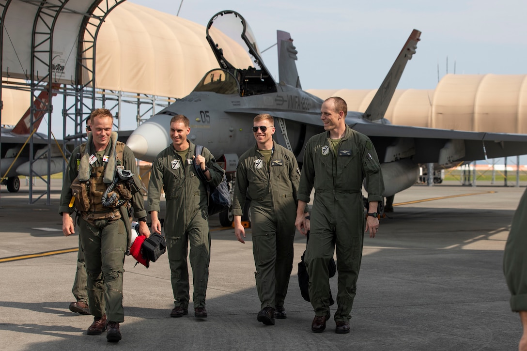U.S. Marines with Marine Aircraft Group 12, 1st Marine Aircraft Wing, walk off the flight line after landing at Marine Corps Air Station Iwakuni, Japan, Sept. 8, 2025. VMFA-232, an F-18 Hornet squadron from MCAS Miramar, California, deployed to augment MAG-12, 1st MAW under the Unit Deployment Program, which provides U.S.-based units with operational experience in the Indo-Pacific through continuous and overlapping deployments to the region. (U.S. Marine Corps photo by Lance Cpl. Cecilia Campbell)