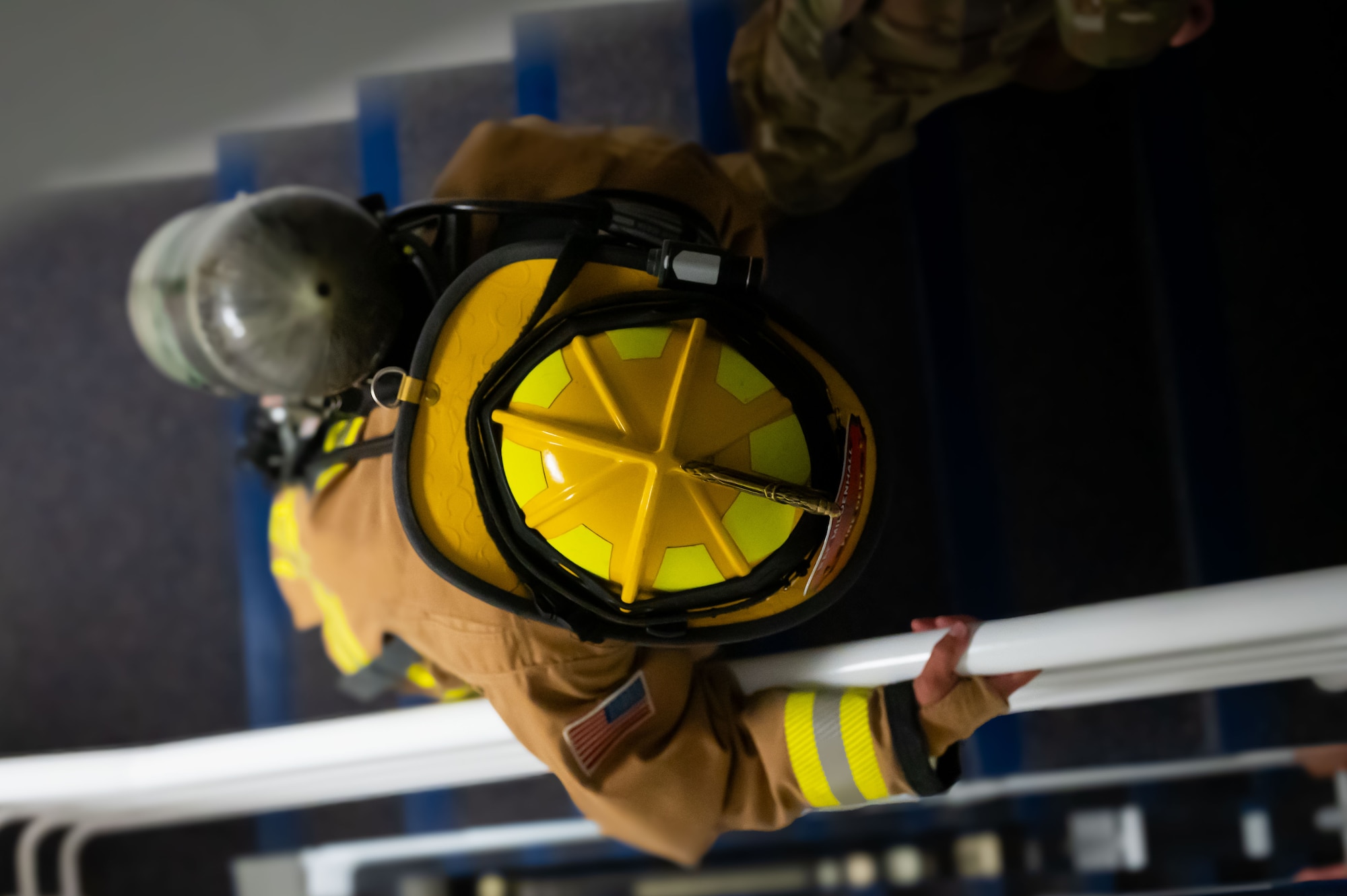 U.S. Air Force Airman 1st Class Jeremiah Crawley, 100th Civil Engineer Squadron firefighter, climbs the stairs of the traffic control tower at RAF Mildenhall, England, Sept. 11, 2025.