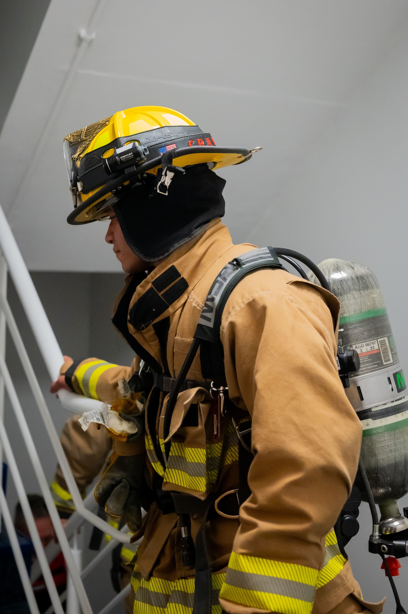 U.S. Air Force Airman 1st Class Jeremiah Crawley, 100th Civil Engineer Squadron firefighter, climbs the stairs of the air traffic control tower during the 9/11 Memorial Climb at RAF Mildenhall, England, Sept. 11, 2025.