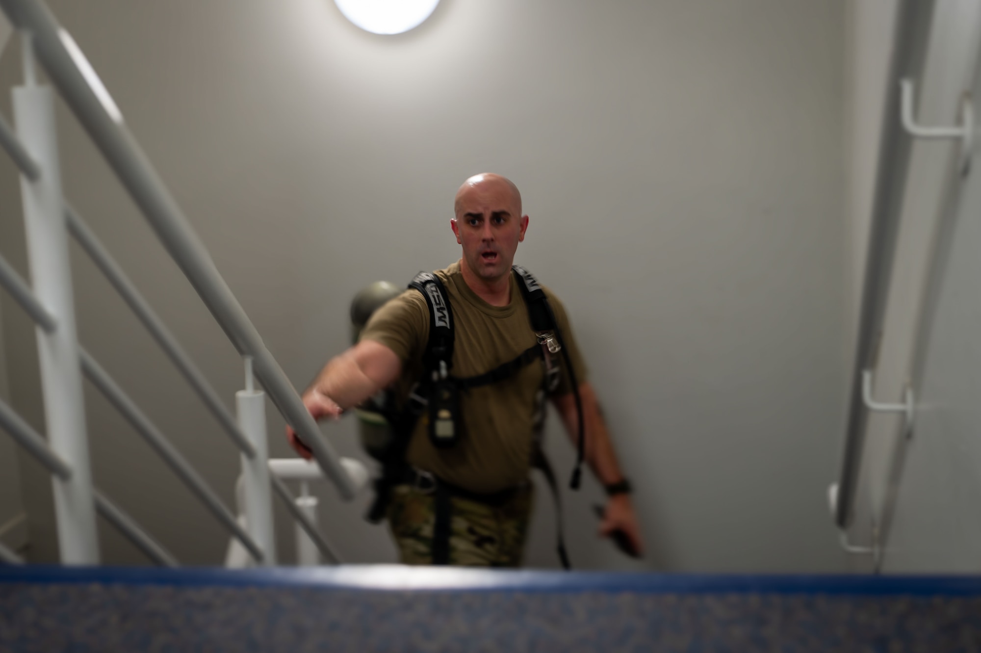 U.S. Air Force Chief Master Sgt. James Wall, 100th Air Refueling Wing command chief, ascends the stairwell of the air traffic control tower during the 9/11 Memorial Climb at RAF Mildenhall, England, Sept. 11, 2025.